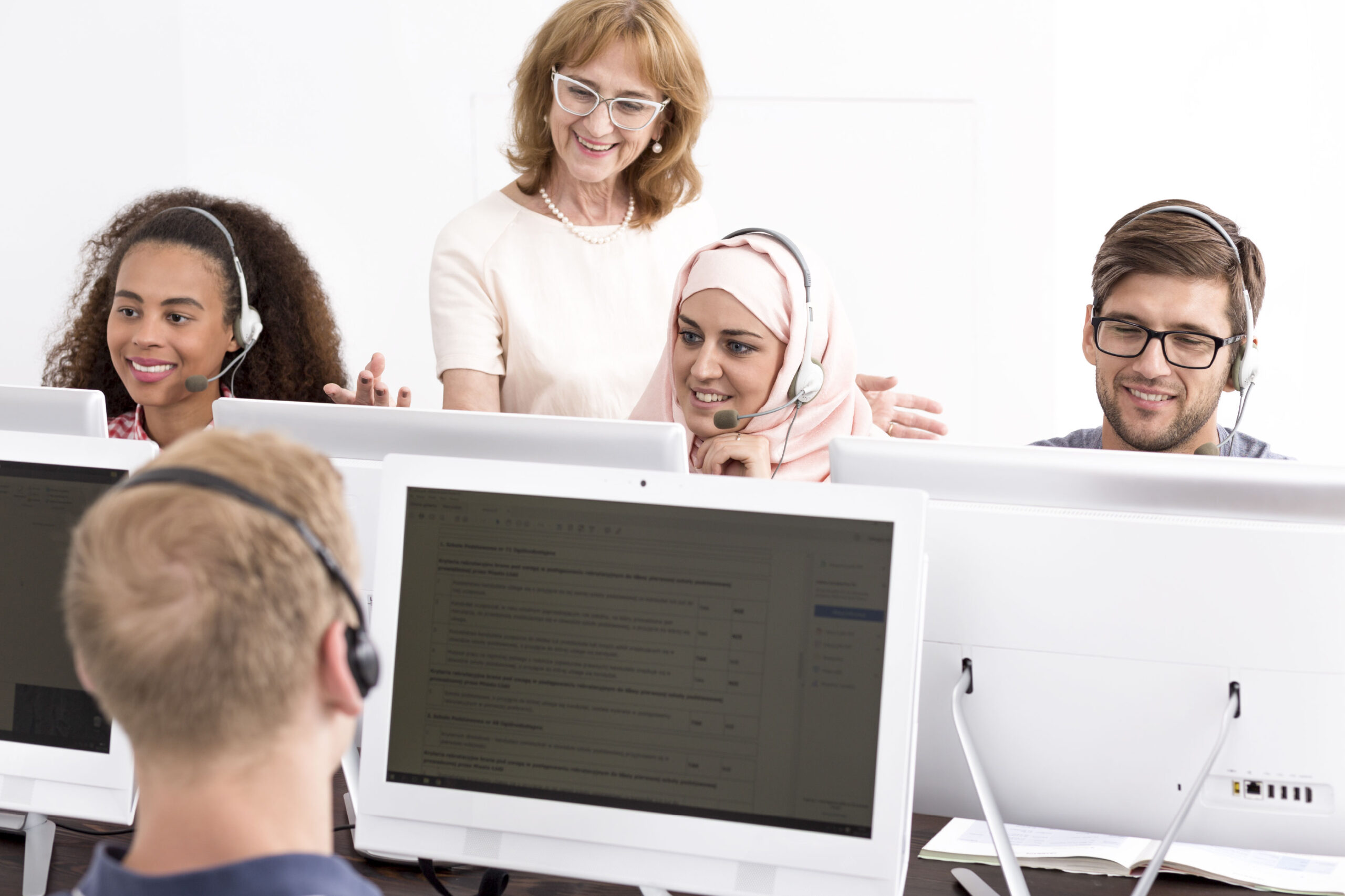 group-of-people-with-earphones-sitting-at-computer-2025-10-10-12-38-19-utc